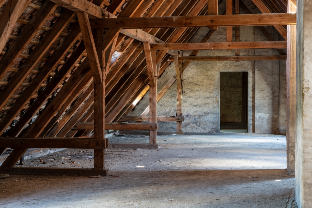 Interior,View,Of,An,Old,Attic,With,Wooden,Beams.